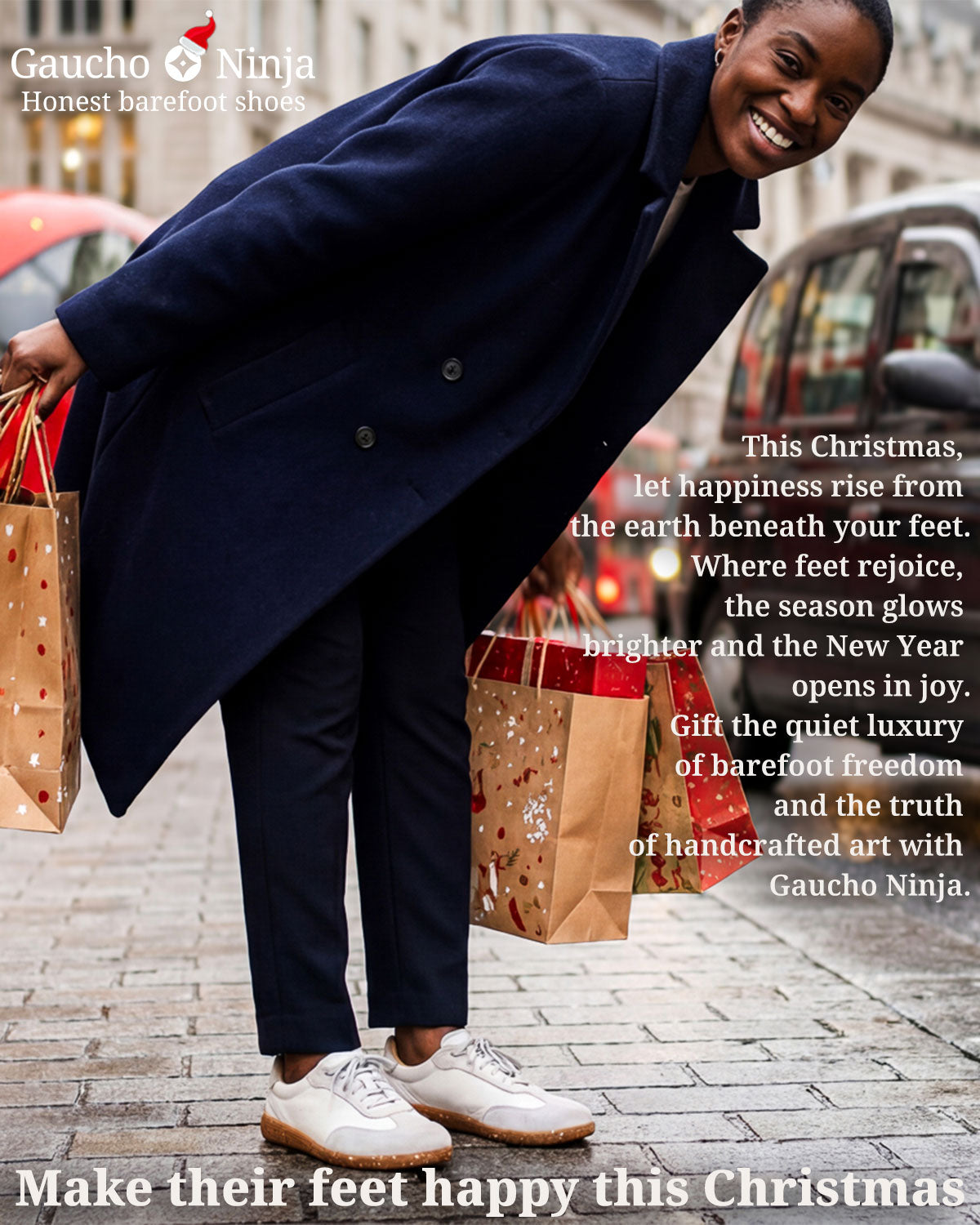 woman with Christmas shopping bags standing on a London street with a black taxi and red buses in the background wearing Gaucho Ninja barefoot trainers