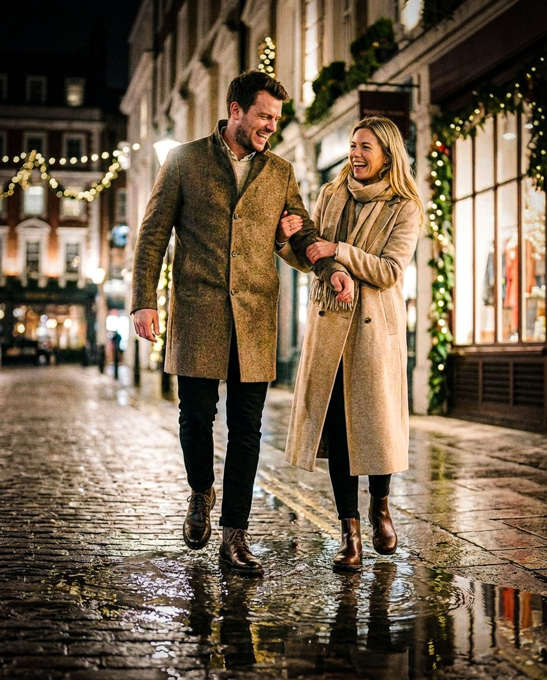 Man and woman wearing Gaucho Ninja barefoot boots in beige coats walking together on a wet street with Christmas decorations.