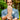 Man holding up a barefoot shoe with a grip sole with a forest background