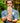 Man holding up a barefoot shoe with a grip sole with a forest background