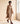 Woman in a camel coat walking in Yazdi Ayr barefoot chukka brogue boots in chocolate brown leather by Gaucho Ninja