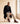 Man in a black coat seated wearing Yazdi Ayr barefoot chukka brogue boots in chocolate brown leather by Gaucho Ninja
